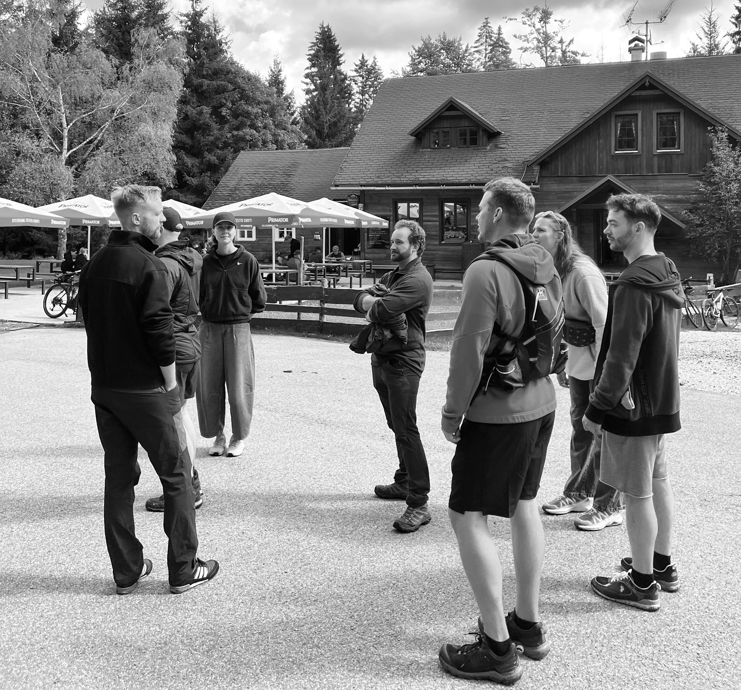 Colleagues gathered outside a mountain lodge.
