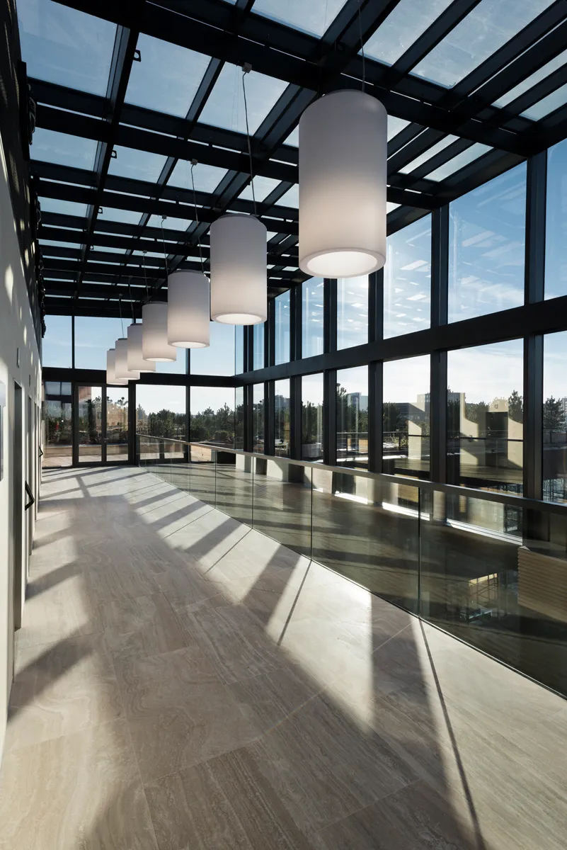 Sunlit glass corridor inside the Delta building
